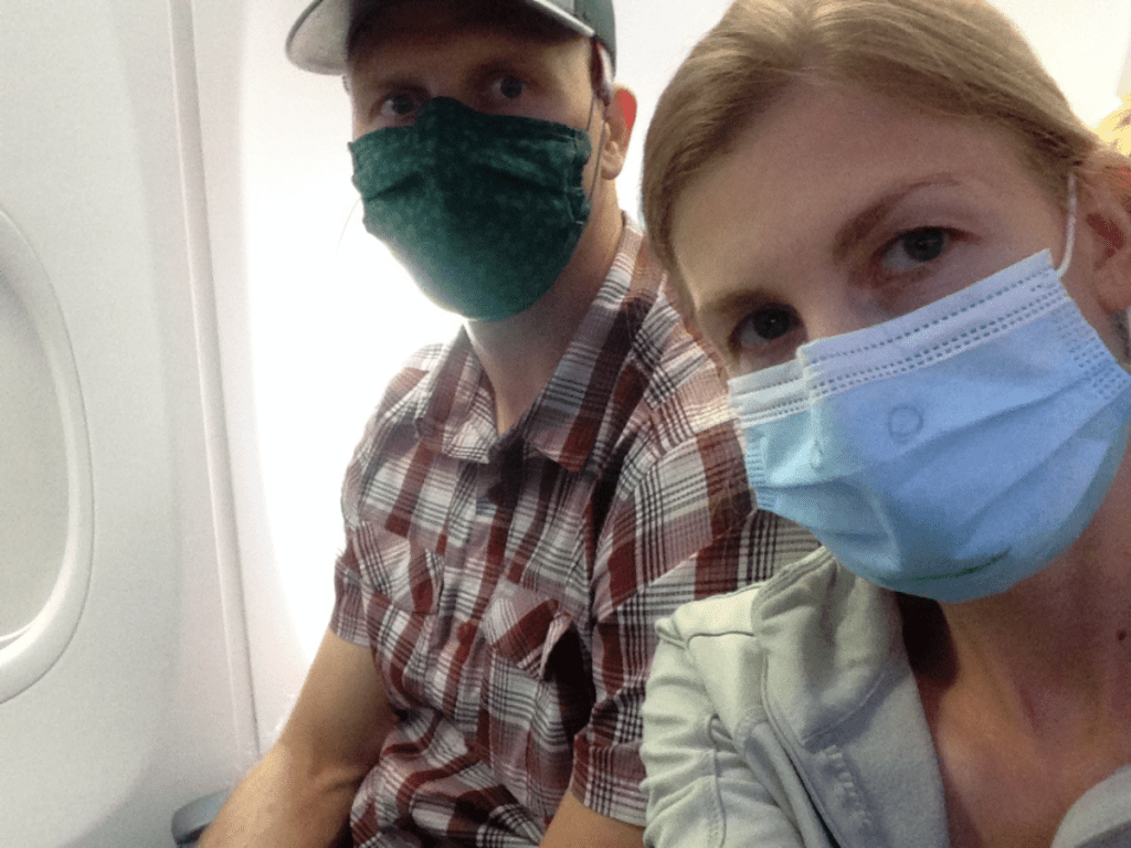 people on airplane wearing masks