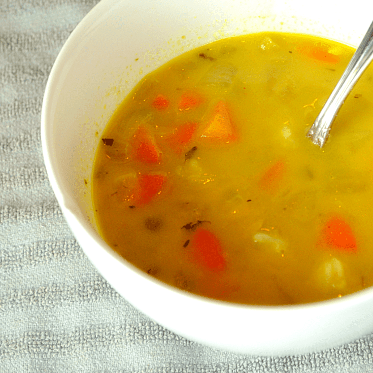yellow soup with carrots, celery and chicken
