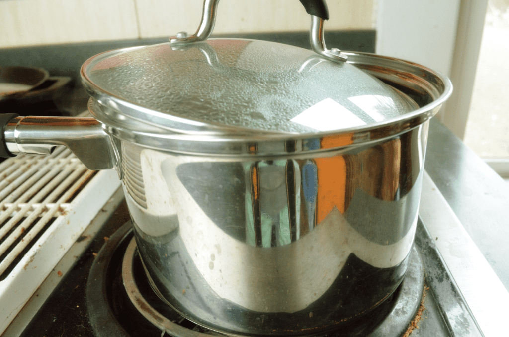 a saucepan sits on stove mostly covered