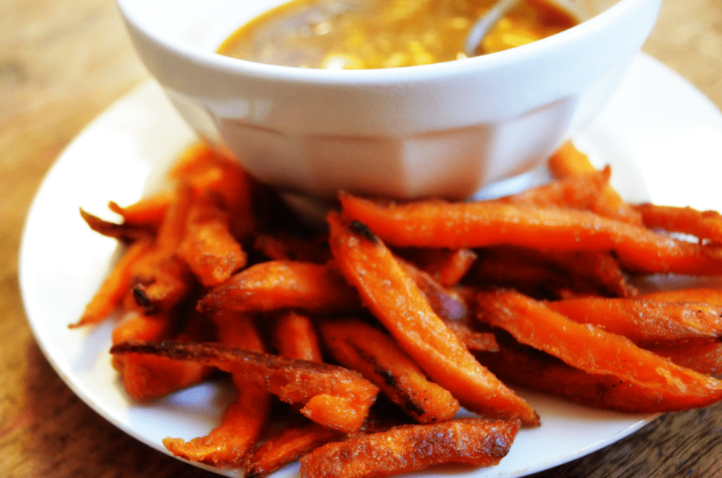 Looking closely at the Finished Alexia Sweet potato fries shows perfectly  browned sides. they glitter in the light from salt and oil ready to be eaten.