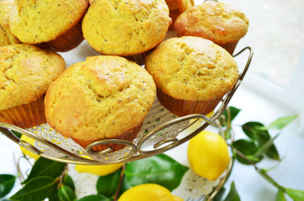 Sourdough Einkorn Lemon Poppy Seed Muffins cluster together looking bright and tasty.