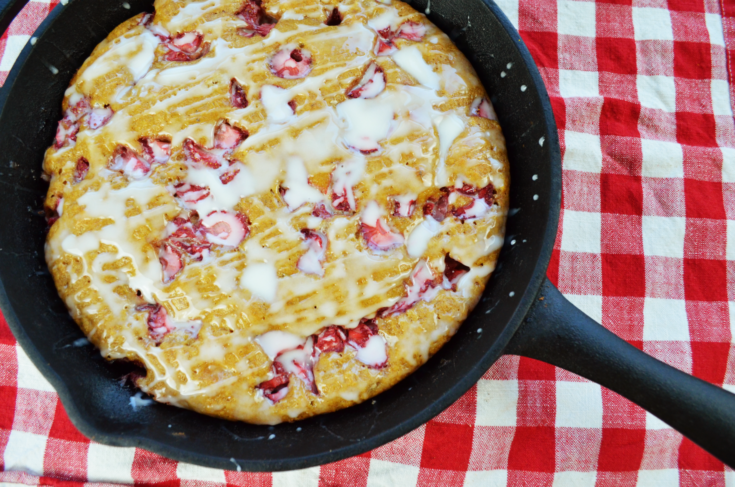 Strawberry scones in an iron skillet on a red gingham tablecloth