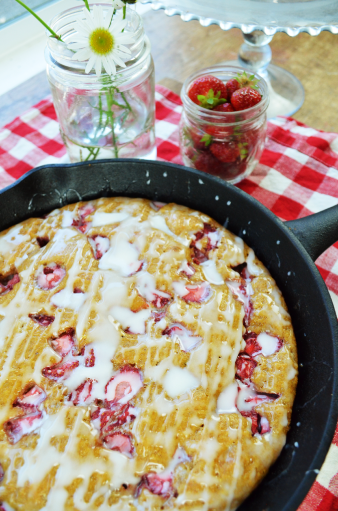 A table is set with glazed scones made from this einkorn strawberry scone recipe. 