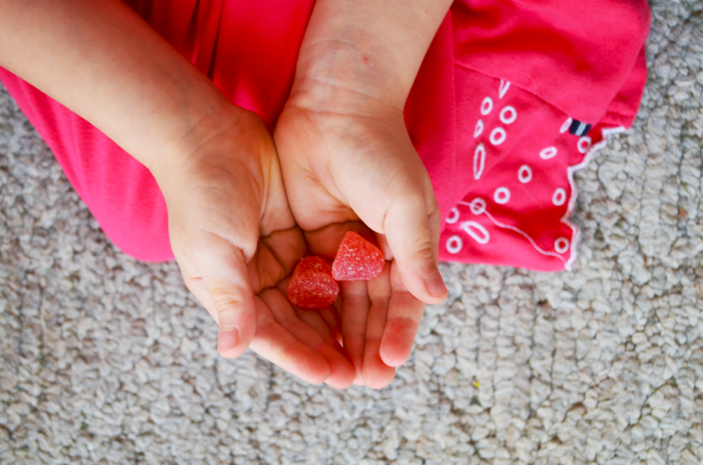 How does adoption affect the child when taking supplements? Child's hands hold vitamins.