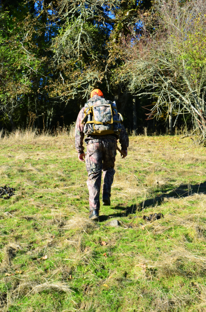 Deer Hunter hiking in wilderness 