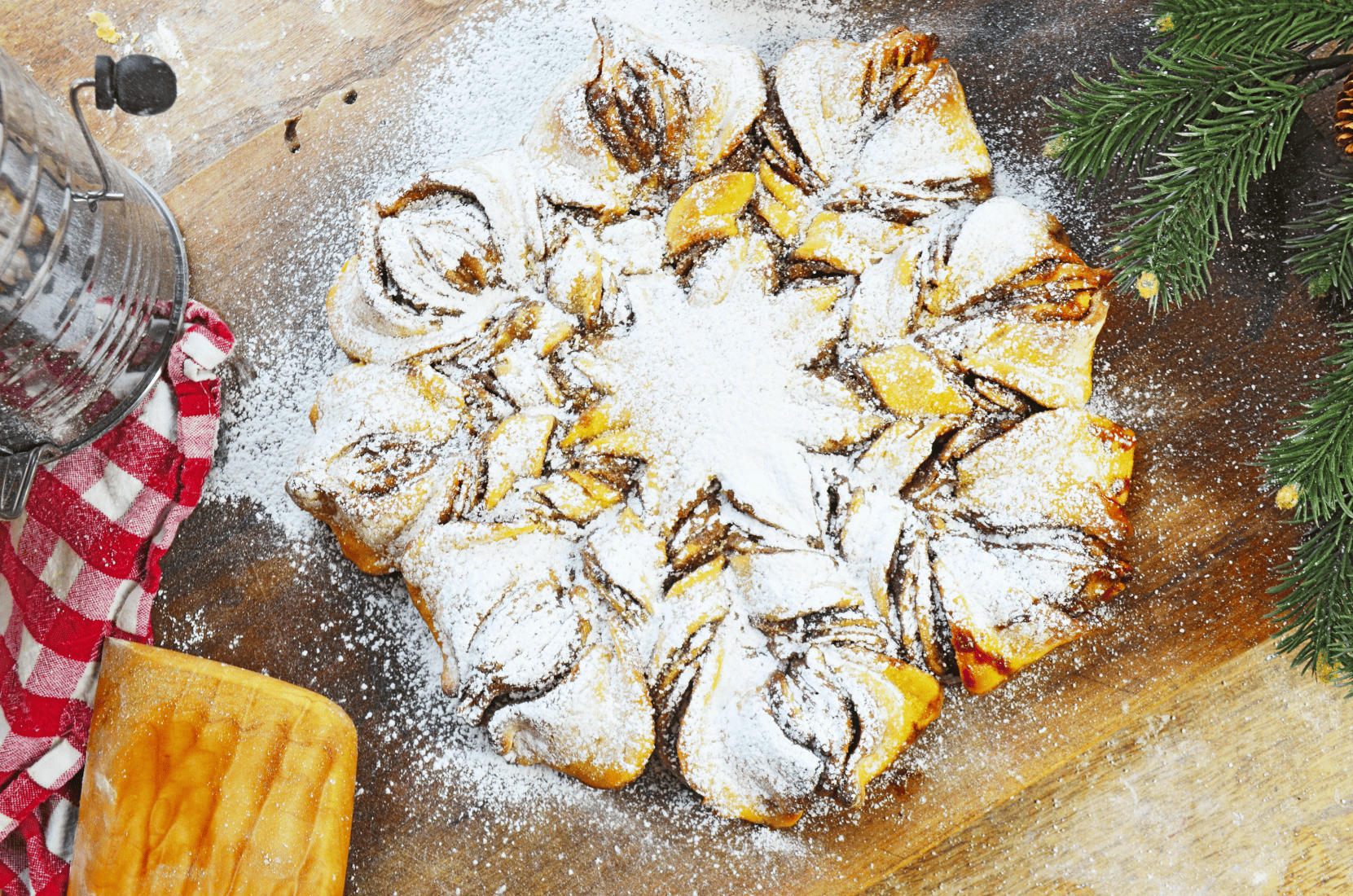 Powder Sugar covered cinnamon streusel sourdough snowflake bread
