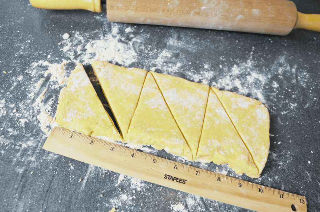 a ruler measures scone dough for slicing into triangles