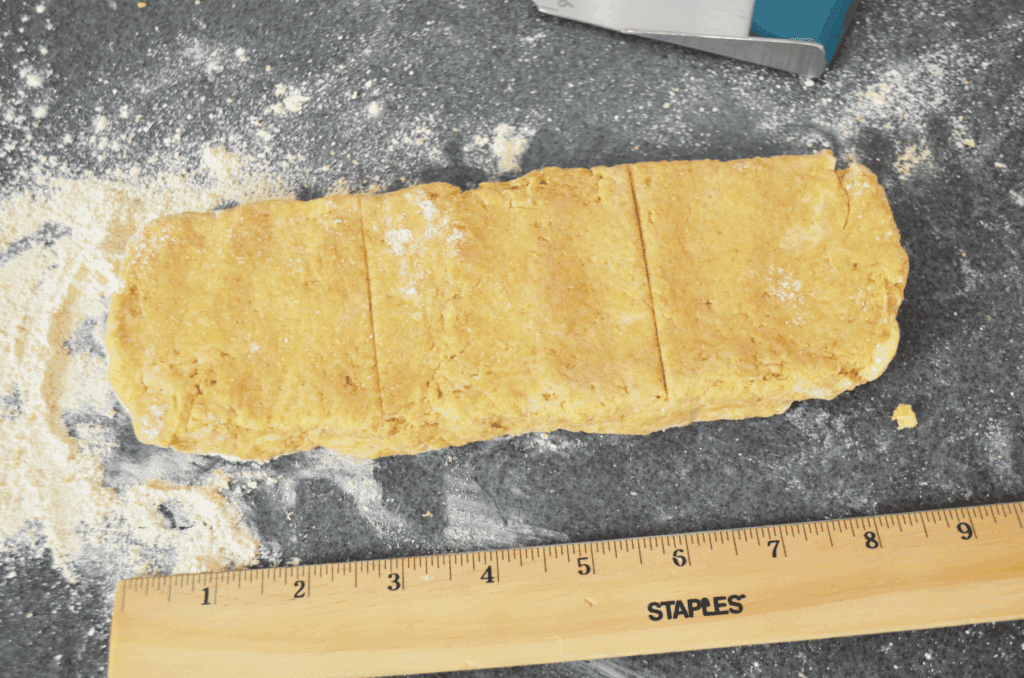 a ruler measures the length of shaped dough for whole wheat einkorn scones.