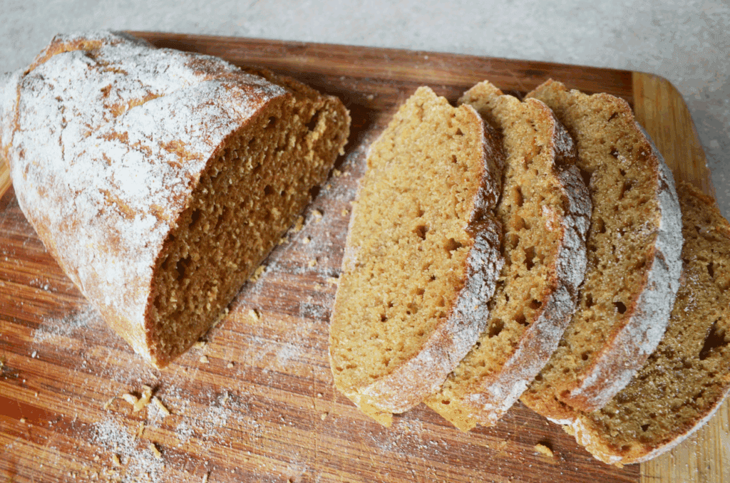 Whole wheat bread loaf slices on a cutting board 