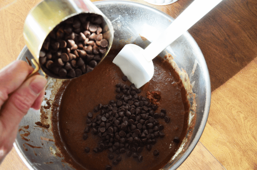Sourdough chocolate muffin batter in bowl with chocolate chips